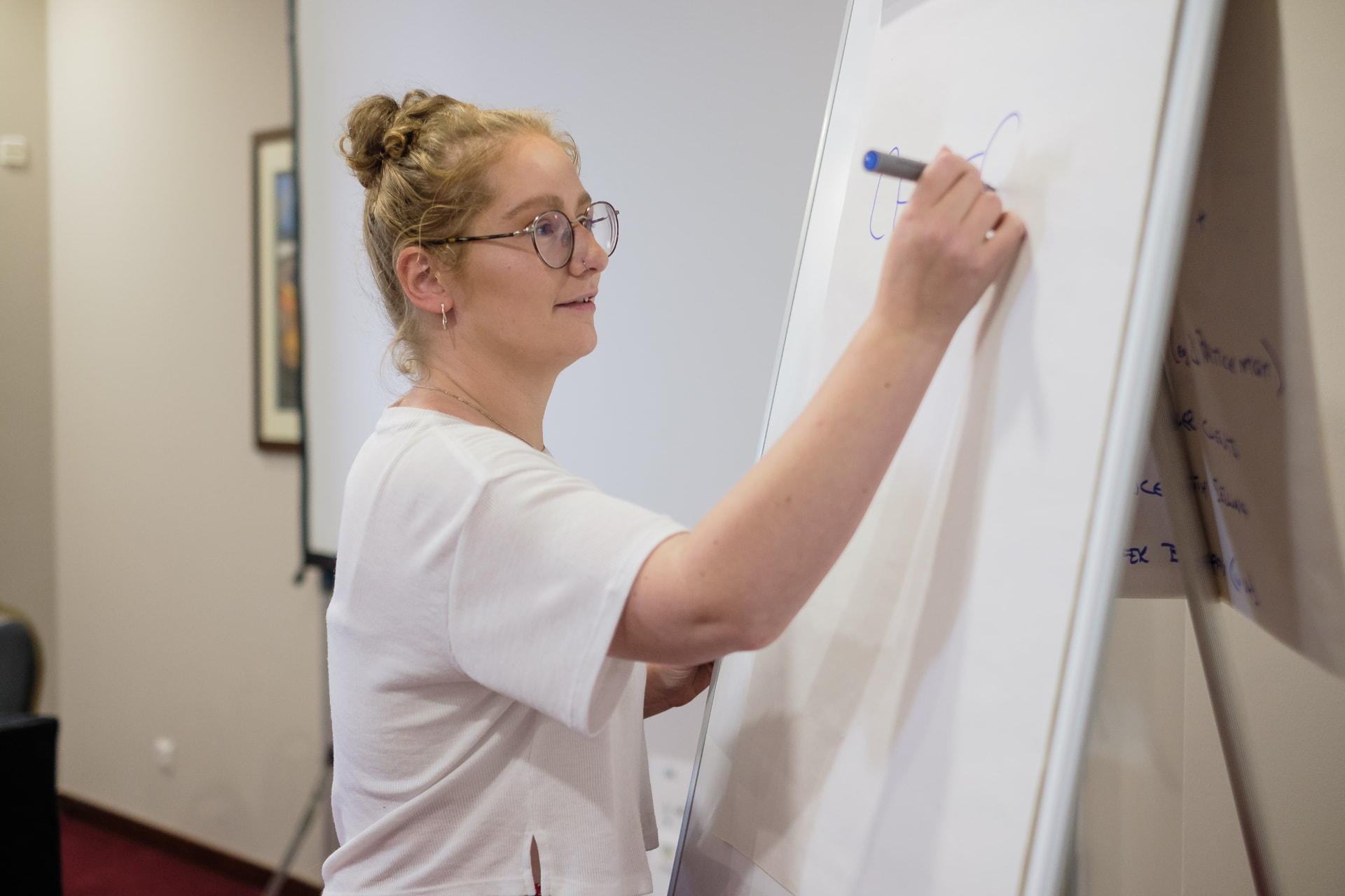 Emily Cross working through a marketing system on a flipchart